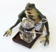 A painted metal inkstand in the form of a seated frog, with associated smaller glass inkwell,