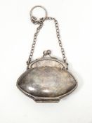 A silver plated purse of shaped oval form with chain handle