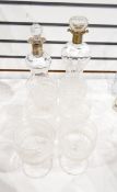 Two cluck-cluck waisted decanters with silver mounts together with set of six strawberry cut