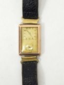 A gent's 9ct gold wristwatch of rectangular form with leather strap Live Bidding:
