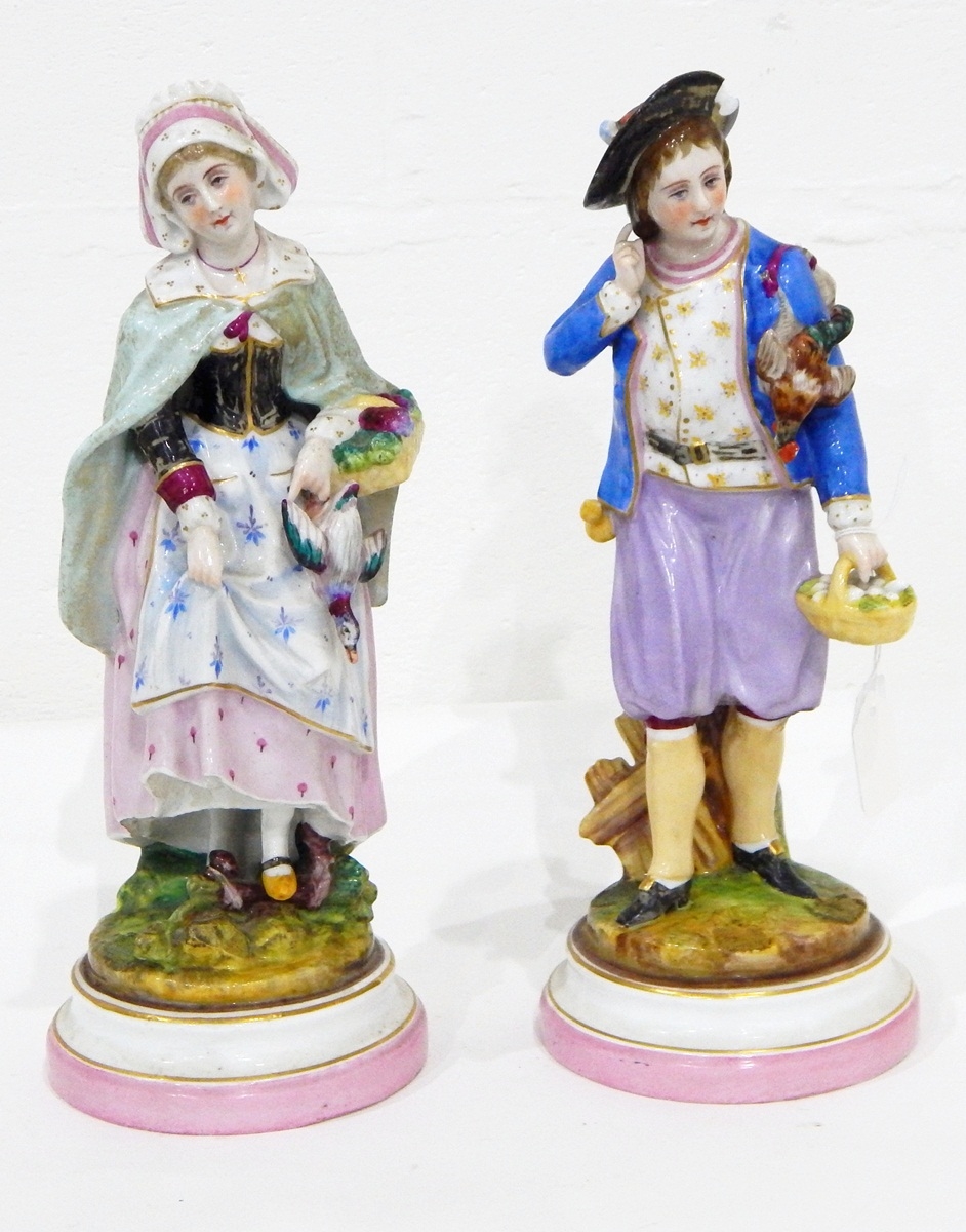 A pair of continental porcelain figures of a boy and girl returning from the hunt,