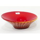 A heavy cased glass flared rim bowl, red and yellow rim and mottled underneath,