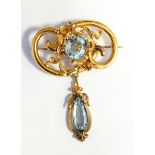 Victorian gold and aquamarine brooch, oval, with pendant of openwork rococo style,