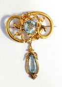 Victorian gold and aquamarine brooch, oval, with pendant of openwork rococo style,