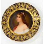 A Vienna porcelain plate, the centre painted with a maiden within a gilt and blue ground border,