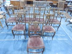 An Edwardian inlaid mahogany seven-piece salon suite comprising a twin chair back settee,