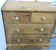 A modern pine chest of two short and two long drawers,