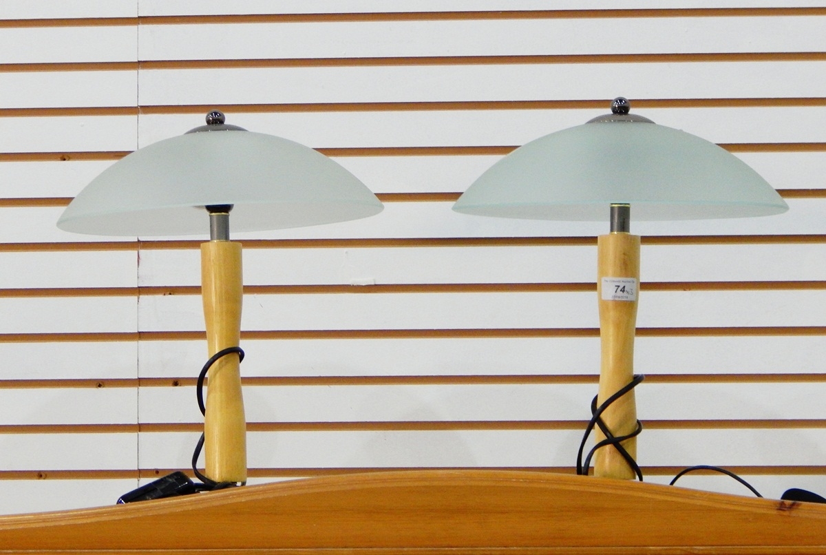 A pair of modern table lamps with glass domed shades and another
