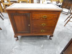 A brass inlaid hardwood cabinet having floral carved border and fitted three drawers with recessed