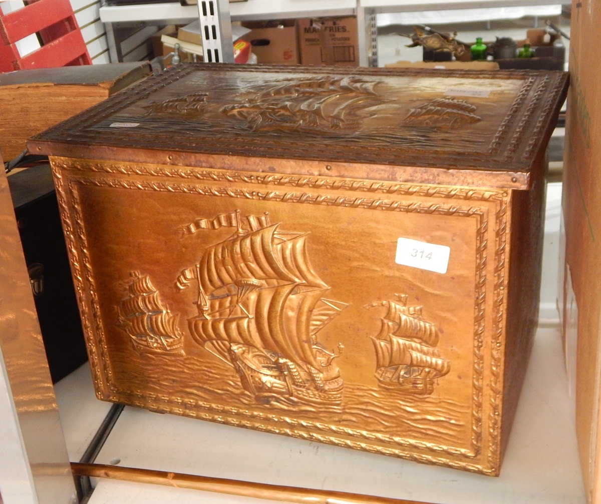 A beaten brass clad slipper box containing assorted brass ornaments, jugs, horns, etc.