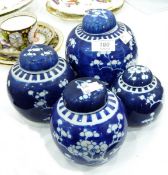 Four blue and white ginger jars and covers of varying sizes, decorated with prunus blossom,