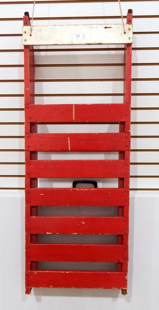 A vintage toboggan/sledge painted red with metal runners