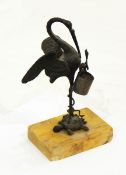 A bronze model crane standing on turtle, on marble base,