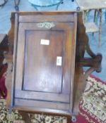 An Edwardian walnut hanging corner cupboard with brass drop handle and plate