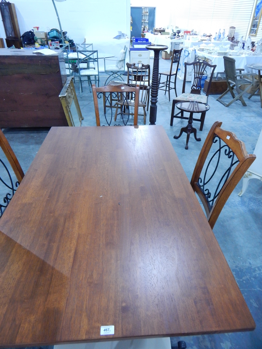 A modern teak finish dining table with metal under-frame and a set of four dining chairs