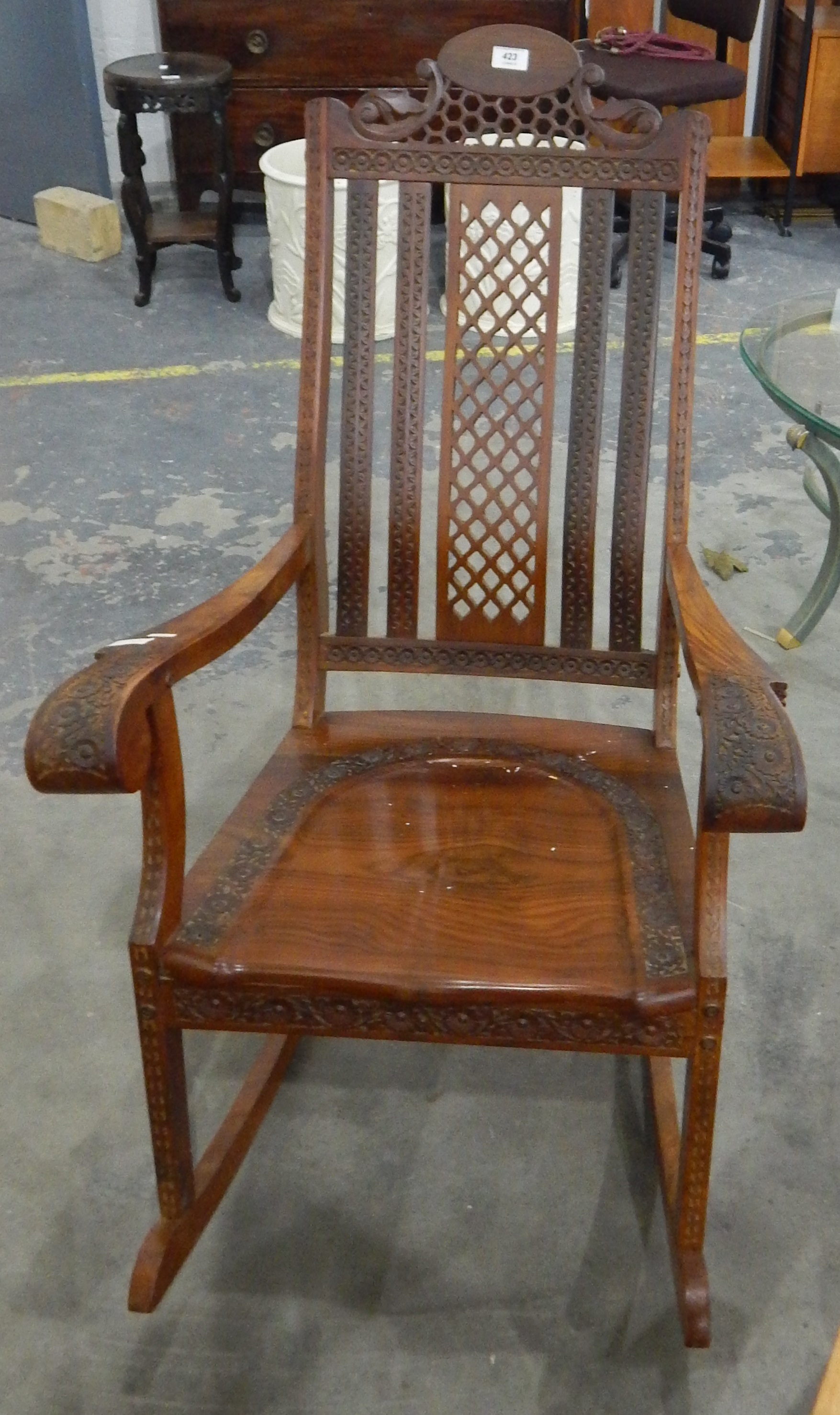 An Oriental carved hardwood rocking chair with pierced lattice crest rail and splat - Image 2 of 2