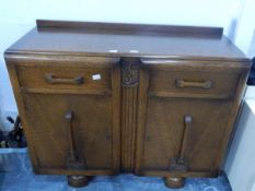 A oak side cabinet on bun feet