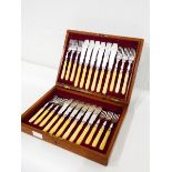 A mahogany cased set of 24 fish knives and forks with engraved decoration,