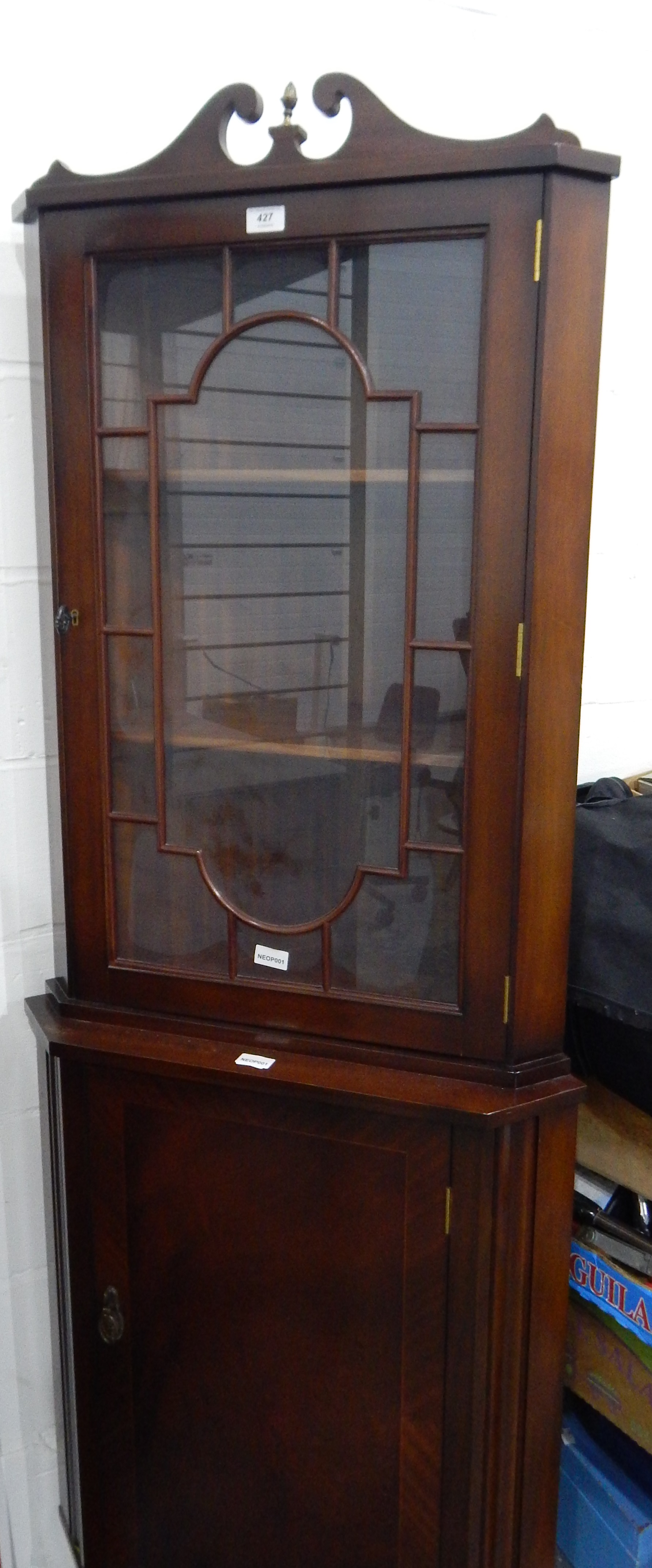 A reproduction mahogany standing corner cupboard,