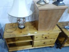 A pine coffee table with magazine rack and fitted two drawers, on turned bun feet,
