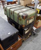 A wood-bound canvas trunk bearing luggage labels and two tin trunks (3)