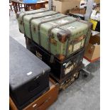 A wood-bound canvas trunk bearing luggage labels and two tin trunks (3)
