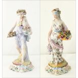 A pair of Meissen style porcelain figurines of ladies in flowing floral robes holding baskets of