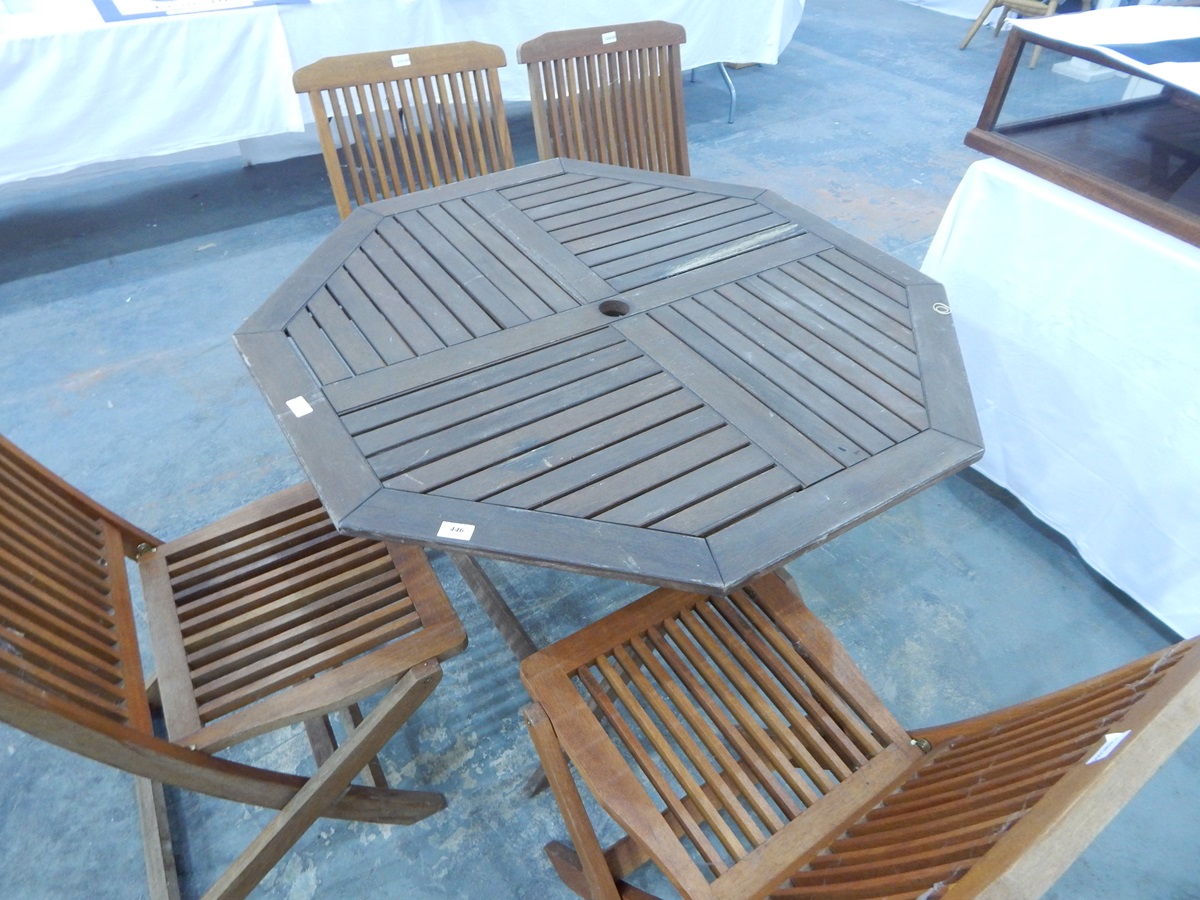 An octagonal hardwood patio table and set of four folding chairs