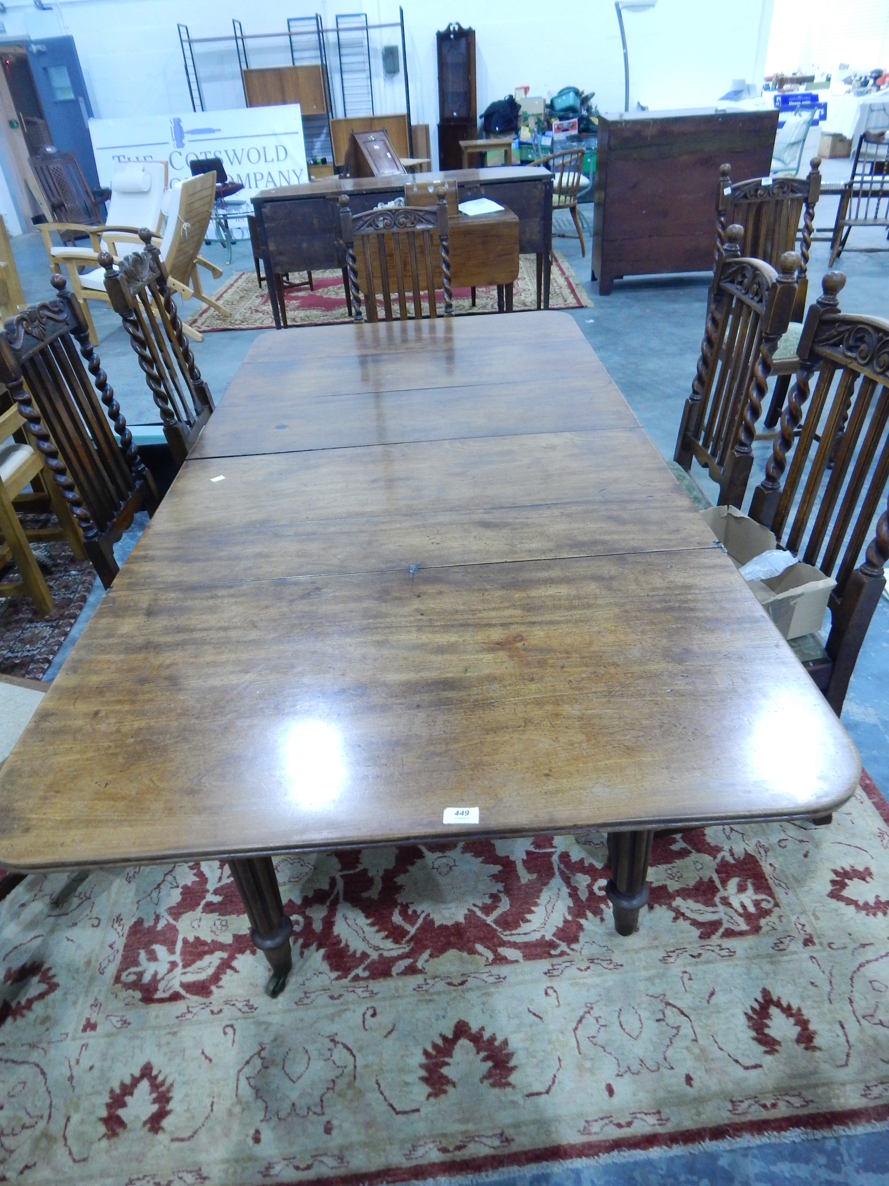 A William IV Gillows extending dining table having six tapering reeded legs and on brass castors,