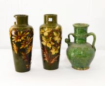 A pair of Exeter Art Pottery vases decorated with yellow flowers on green grounds,