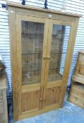 A display cabinet with glass panelled sides and doors,