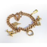 9ct gold charm bracelet with padlock clasp, approx.