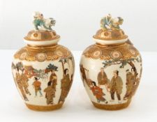 A pair of Japanese Satsuma ware jars and covers, each finely painted with figures,
