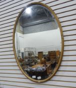 An oval bevelled plate wall mirror in moulded frame