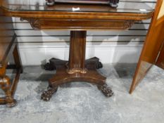 A Victorian mahogany fold-over card table raised on square tapering column with quatrefoil base and