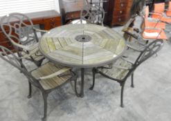 An oak and metal framed patio set comprising circular segmented table and set of four chairs