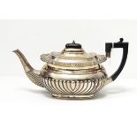 A late Victorian silver teapot by John Round & Son, Sheffield 1896 of oval half-fluted form,