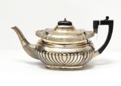 A late Victorian silver teapot by John Round & Son, Sheffield 1896 of oval half-fluted form,