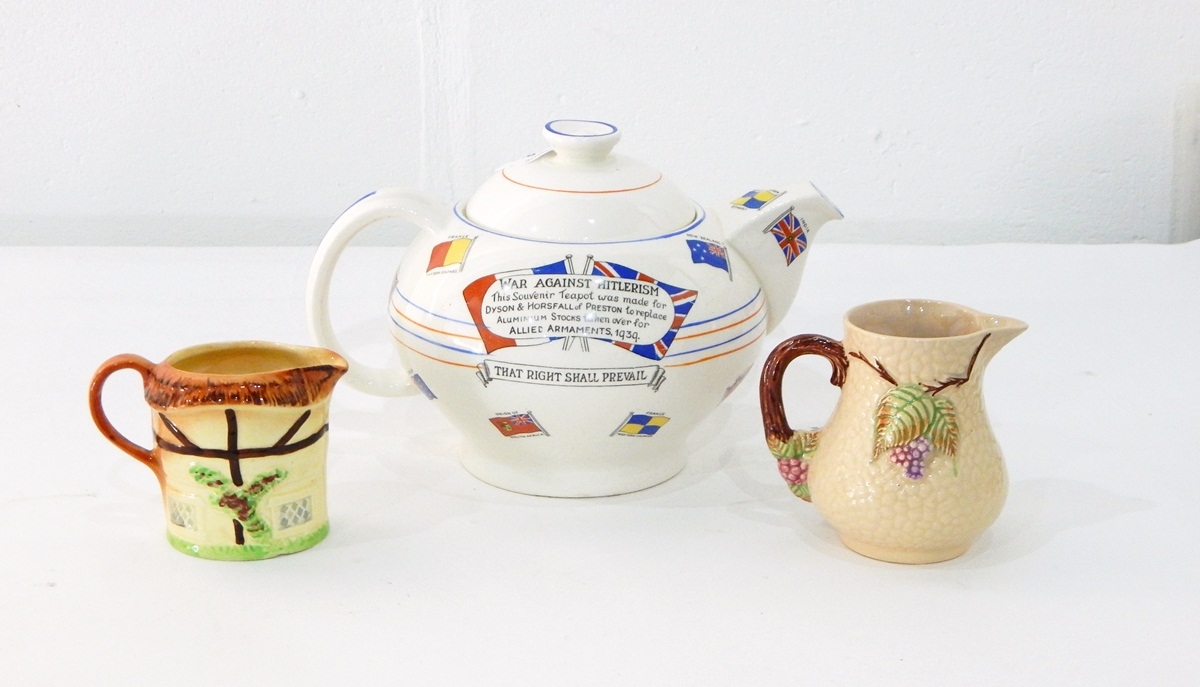 A Crown Ducal ware souvenir teapot decorated with flags,