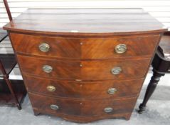 An early 19th century mahogany bowfront chest of four drawers, shaped apron and bracket feet,