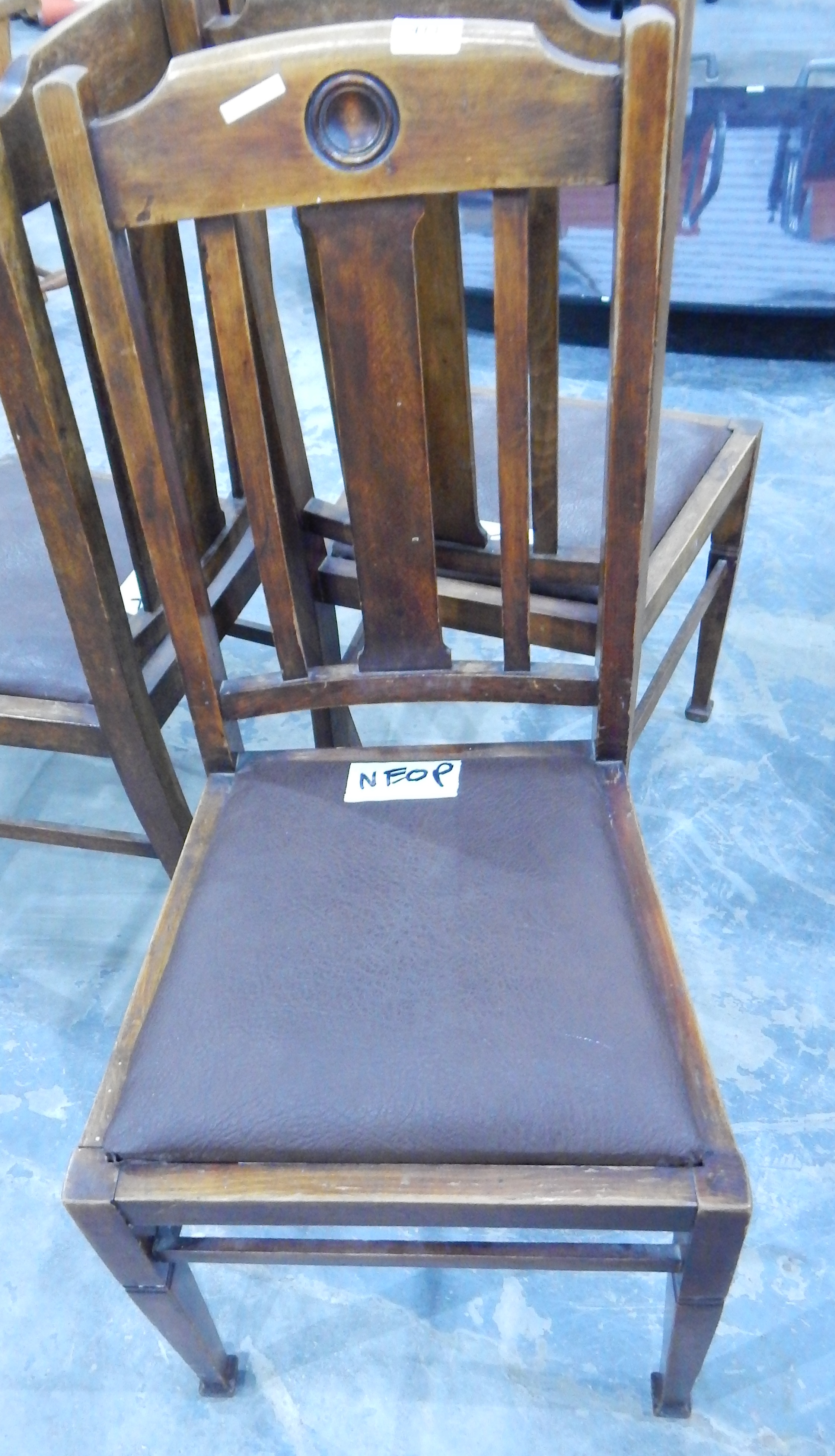 A set of three circular 1930's oak framed dining chairs