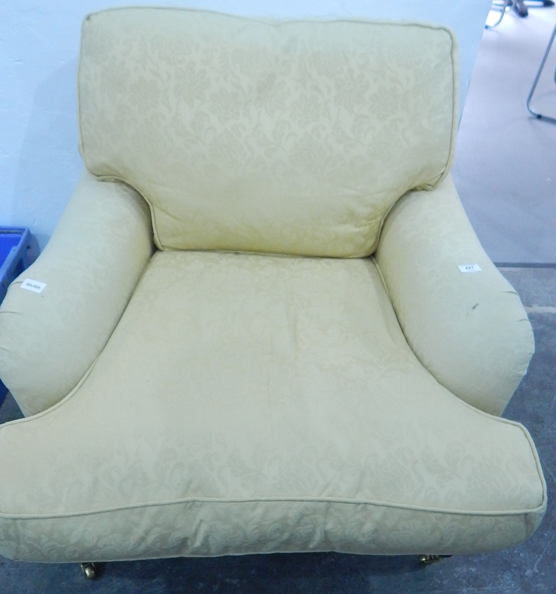 A wingside armchair with similar upholstery