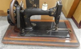 Old iron sewing machine in inlaid case and two mirrors