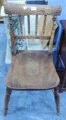 A late 19th/early 20th century oak kitchen chair with turned spindle back