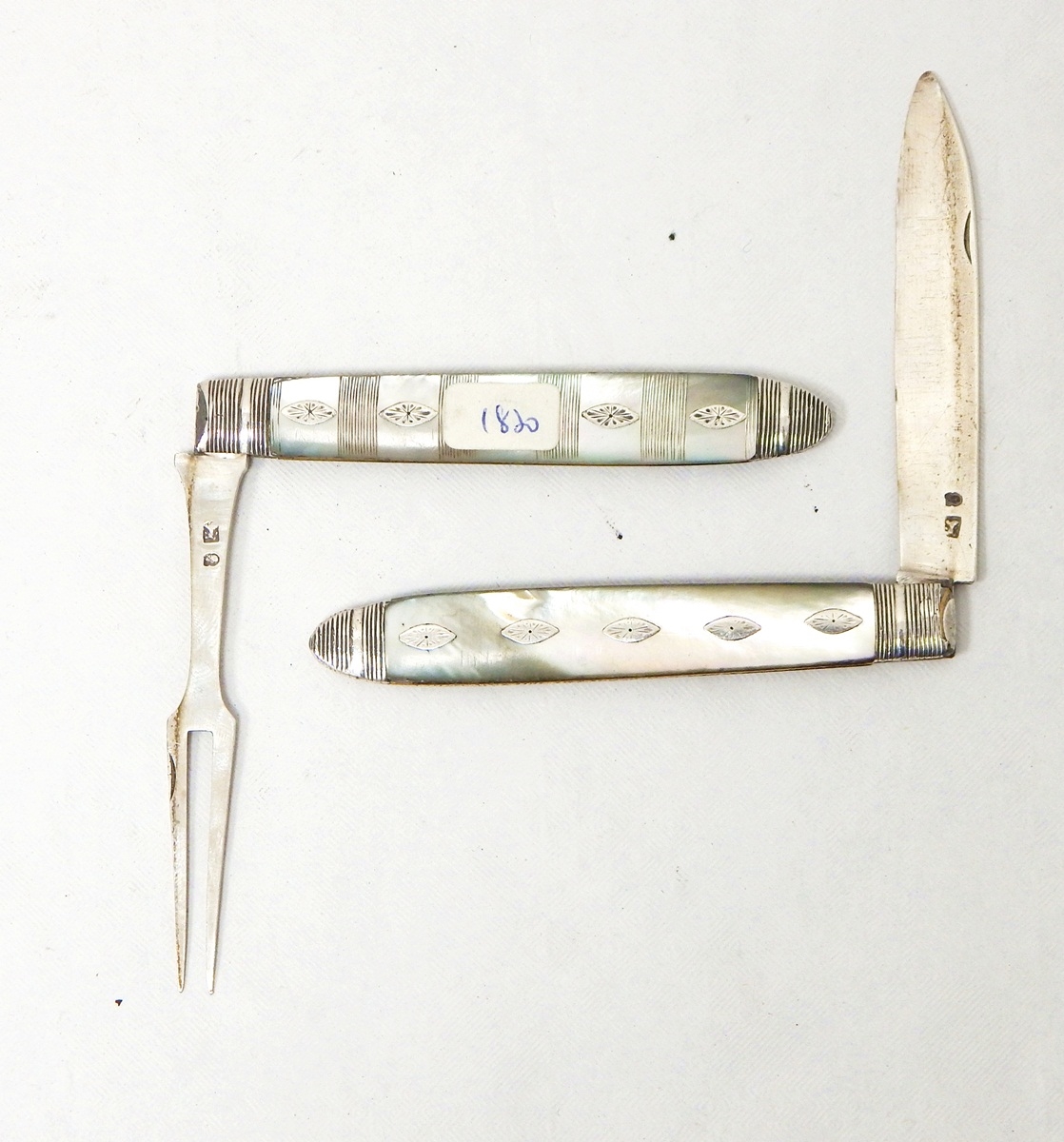 A Georgian silver knife and folding fork set with mother-of-pearl handles, insert metal decorations, - Image 2 of 3