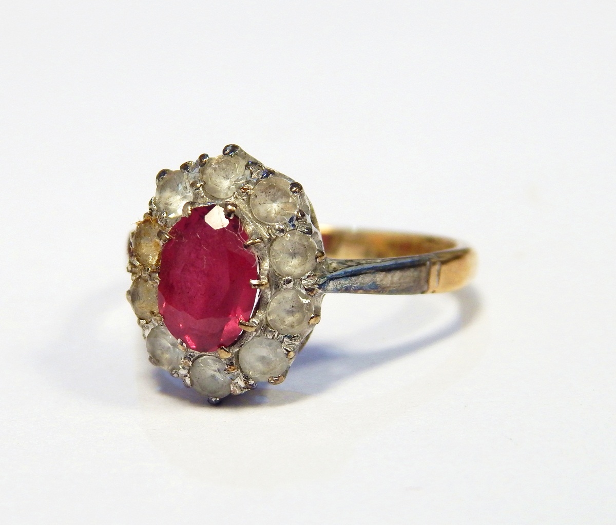 Pink stone and diamond cluster ring set oval facet-cut pink stone,