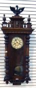 A late Victorian Vienna-style wall clock, the pediment with carved eagle finial, turned finials,