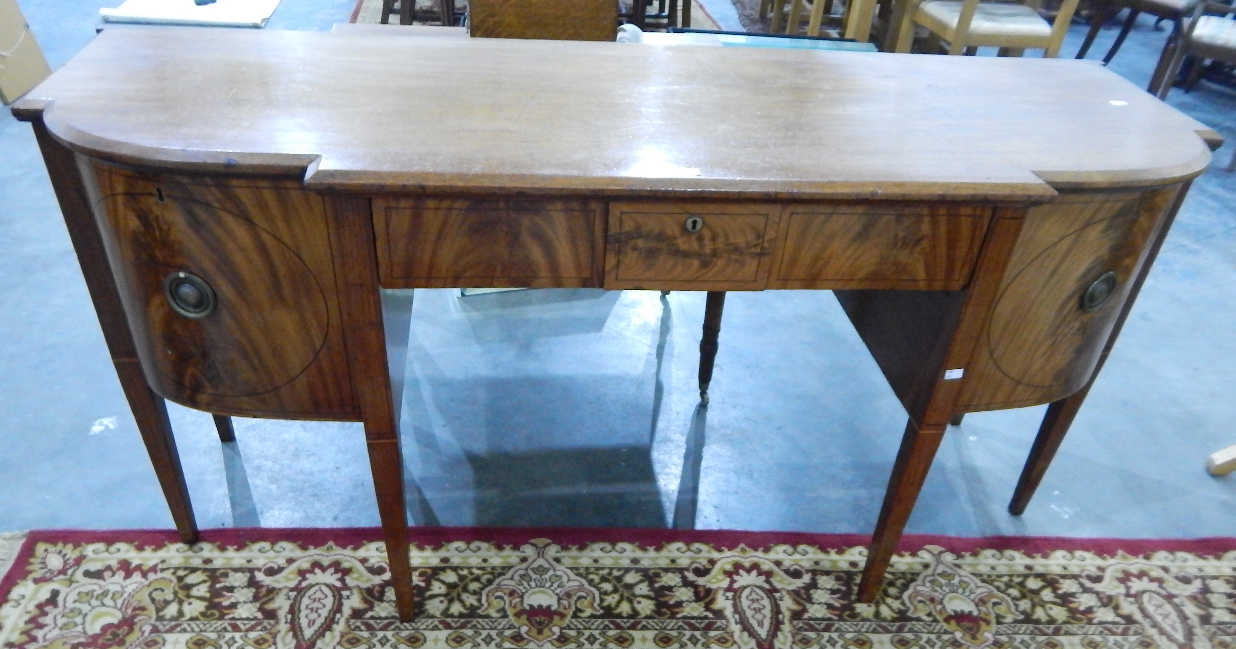 A George III mahogany breakfront bull-nosed sideboard,