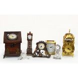 A quantity of carved wood and other decorative items including brass lantern clock,