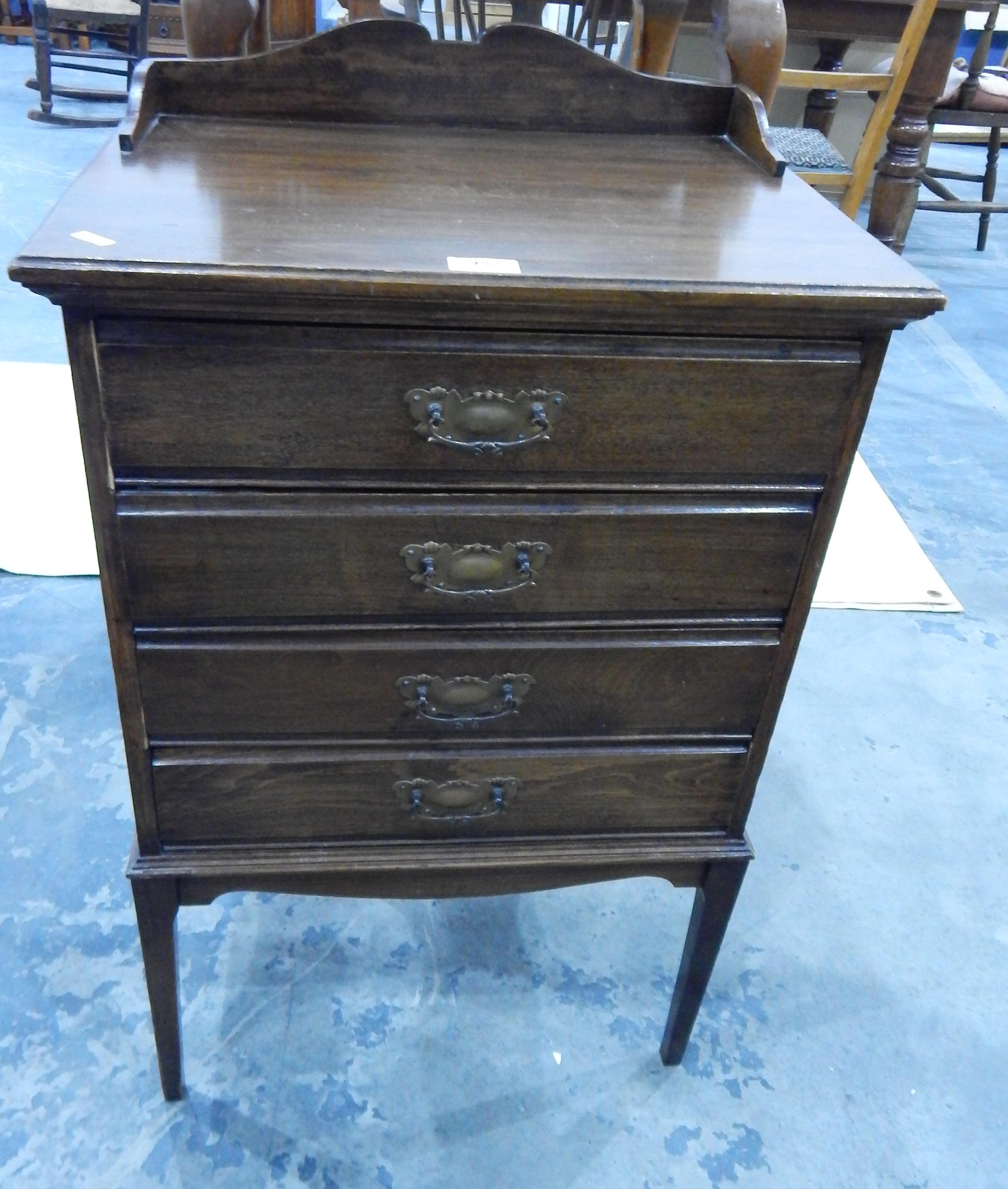 An Edwardian four tray music cabinet with raised shaped backboard